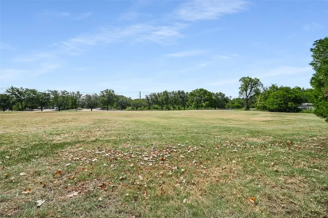 a view of a field with an ocean view