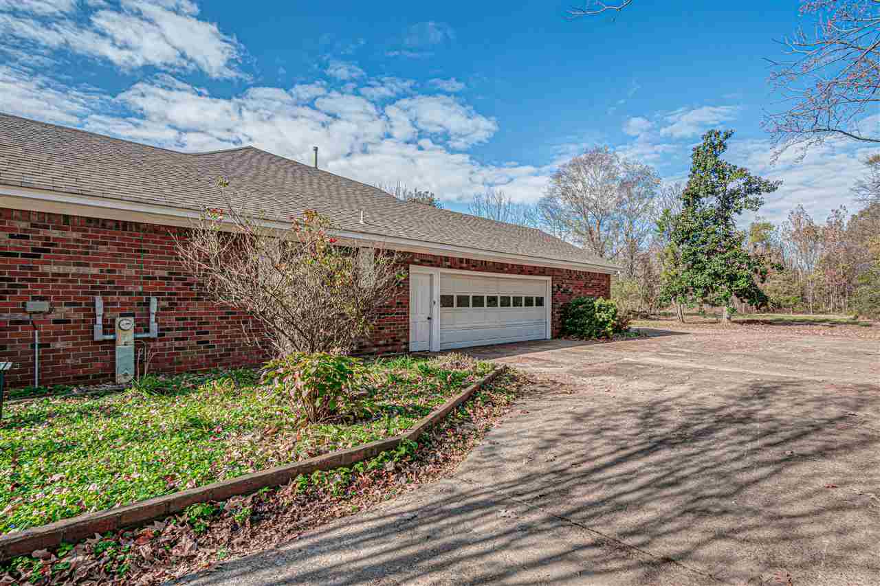 5230 Bateman Road Millington, TN 38053 - Photo 18 of 22 Workshop inside garage and extra driveway pad that wraps around back of home.