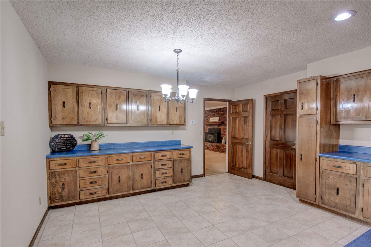 New light fixture for over your breakfast table. Adjoining the eat in Kitchen. This massive area can fit a large family dining table, with plenty of storage space! The door leads to 2 car garage and workshop