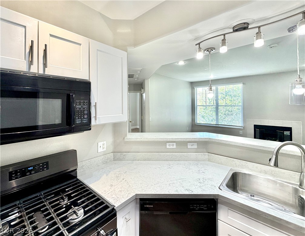 8555 West Russell Road, Unit 2018 Las Vegas, NV 89113 - Photo 6 of 23 A well-appointed kitchen features modern appliances and a convenient pass-through to the living area.