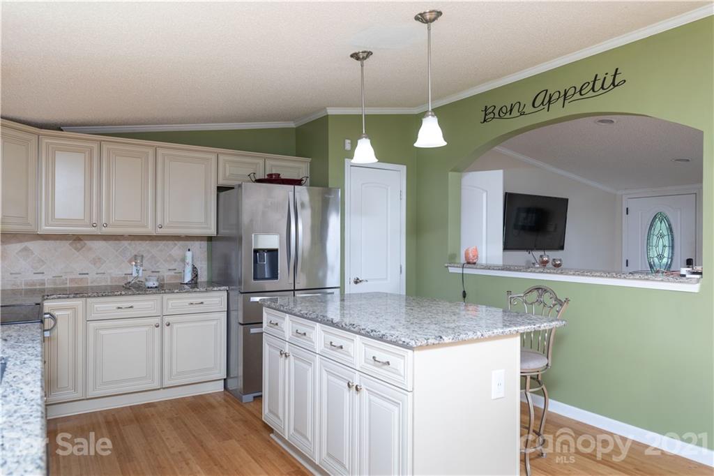 2841 Hart Road Clover, SC 29710 - Photo 11 of 26 a kitchen with kitchen island granite countertop a sink a counter top space cabinets and stainless steel appliances