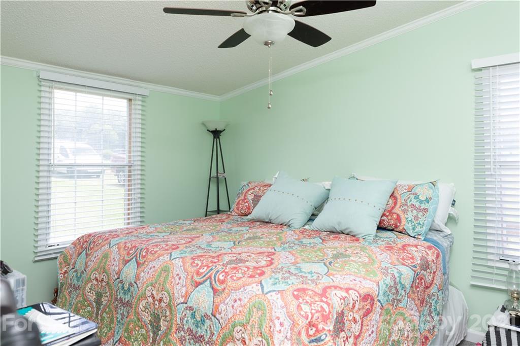 2841 Hart Road Clover, SC 29710 - Photo 15 of 26 a bedroom with a large bed and a chandelier
