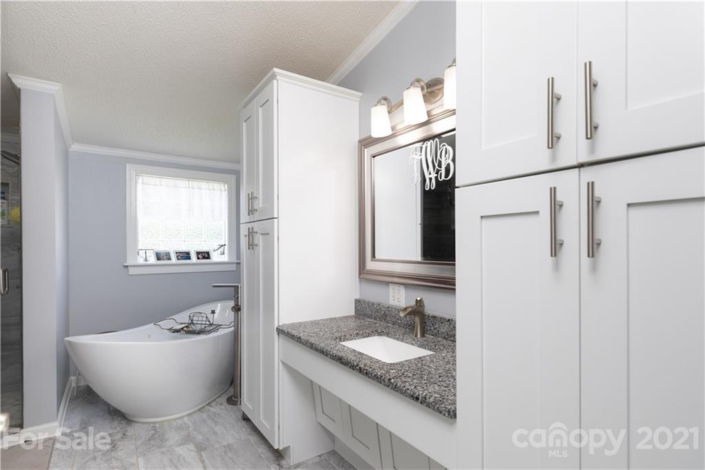 2841 Hart Road Clover, SC 29710 - Photo 22 of 26 a bathroom with a granite countertop sink and a mirror