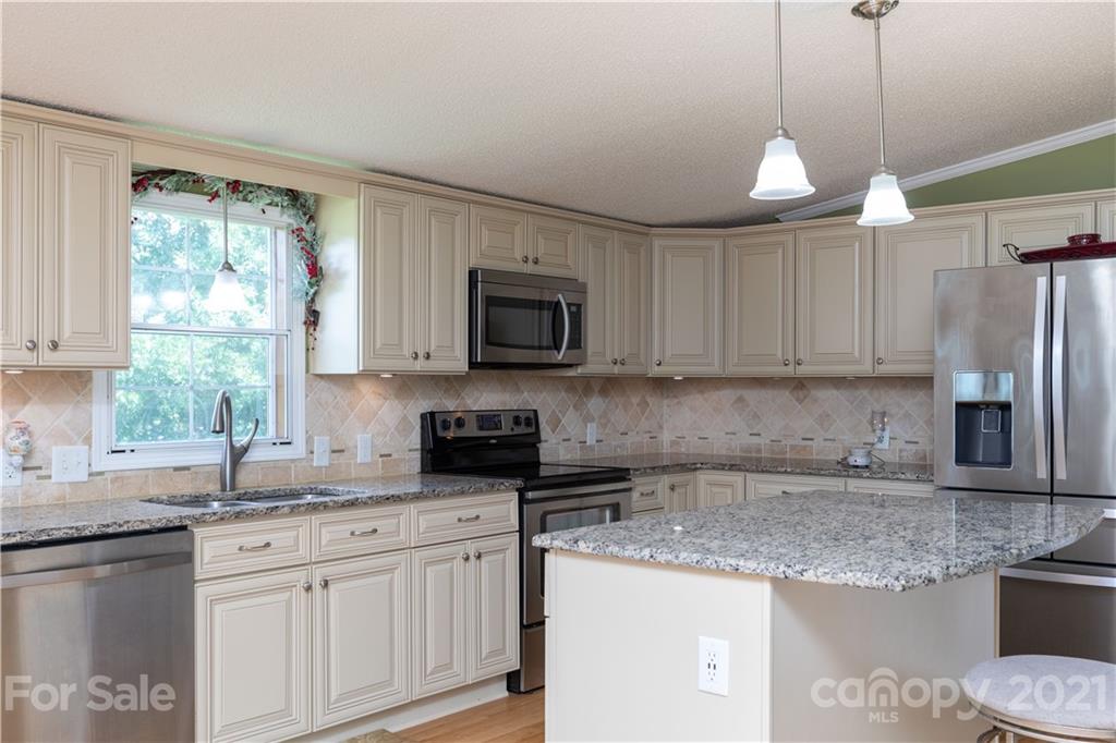 2841 Hart Road Clover, SC 29710 - Photo 9 of 26 a kitchen with granite countertop a sink a counter space appliances and cabinets