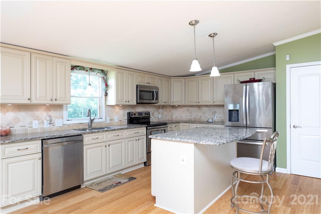 2841 Hart Road Clover, SC 29710 - Photo 10 of 26 a kitchen with a sink a center island cabinets and stainless steel appliances
