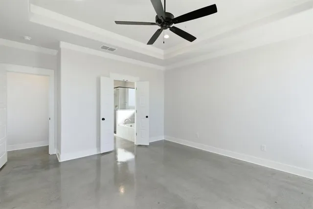 an empty room with closet and fan