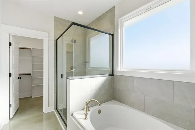 a bathroom with a bathtub and a shower