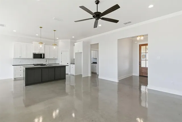 a view of kitchen with refrigerator and window
