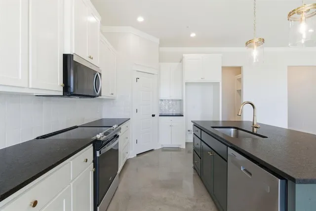 a kitchen that has a sink and a stove