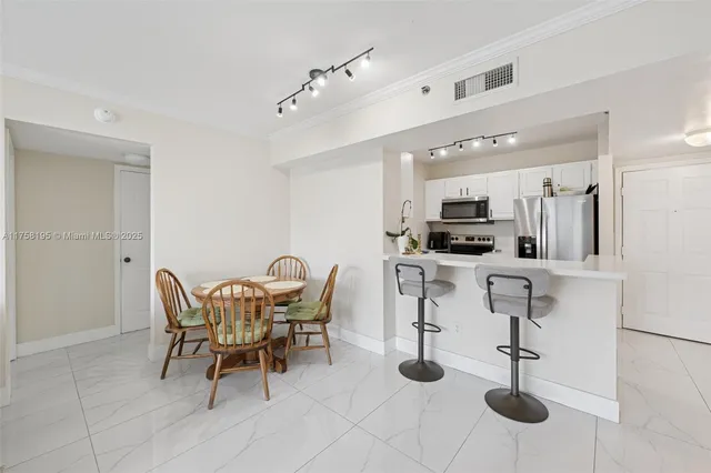 a view of kitchen with cabinets and wooden floor