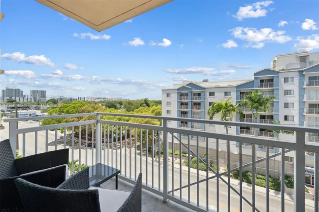 a view of a chairs and table in the balcony