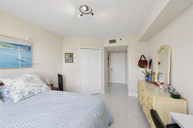 a bedroom with a bed and a mirror