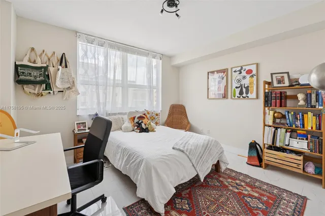 a bedroom with a bed a book shelf and a window