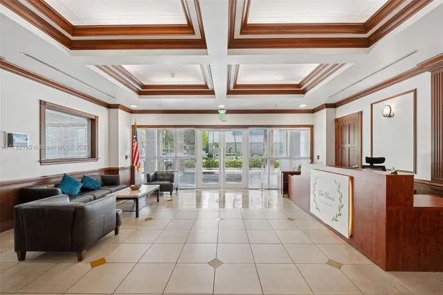 a living room with furniture and large windows