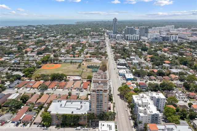 an aerial view of residential building with parking