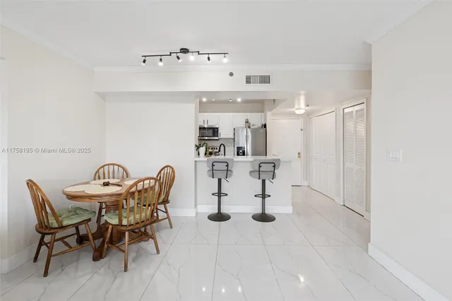 a dining room with furniture and a chandelier