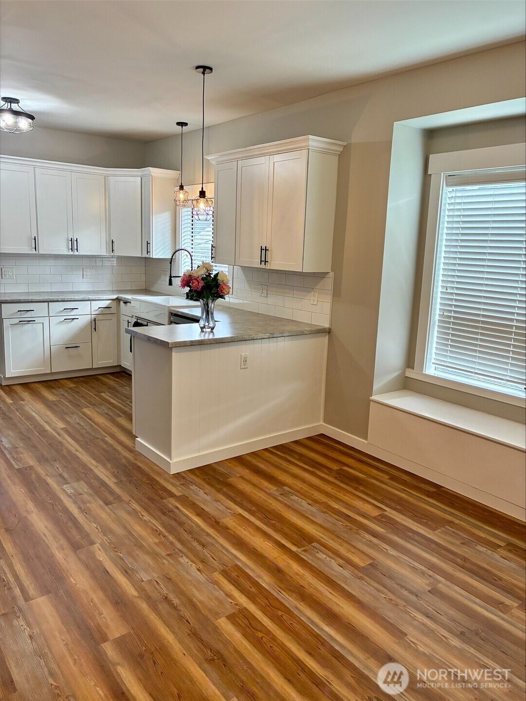 310 Second Street Sumas, WA 98295 - Photo 9 of 26 a kitchen with kitchen island granite countertop a sink cabinets and wooden floor