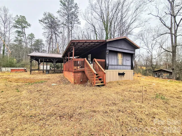 a view of a house with a yard covered in snow