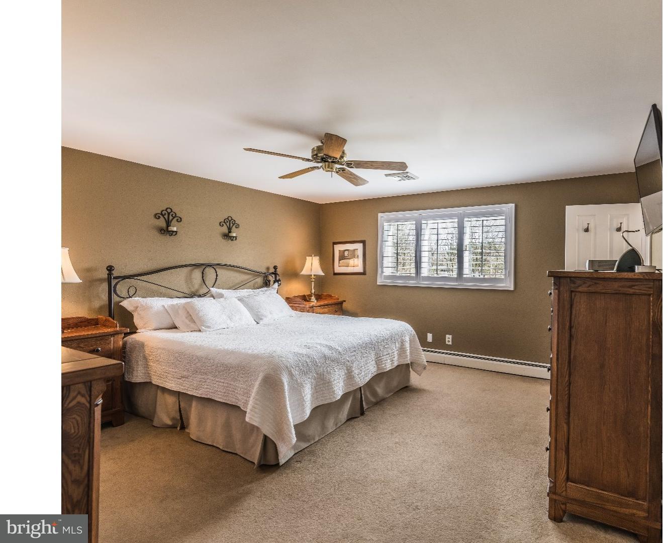 10 Doe Run Road Warrington, PA 18976 - Photo 3 of 7 a bedroom with a bed and a ceiling fan