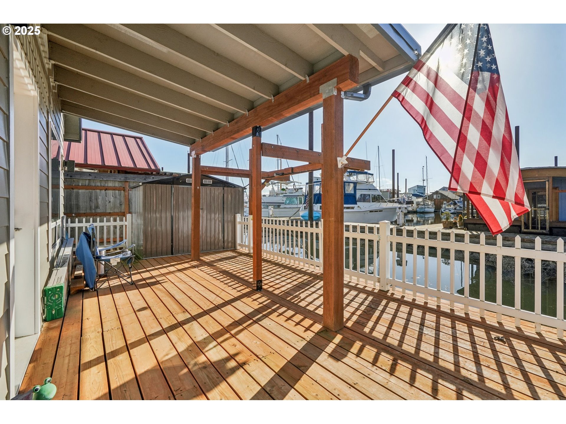 34326 Johnson's Landing Road, Unit E1 Scappoose, OR 97056 - Photo 18 of 21 a view of a balcony with wooden floor