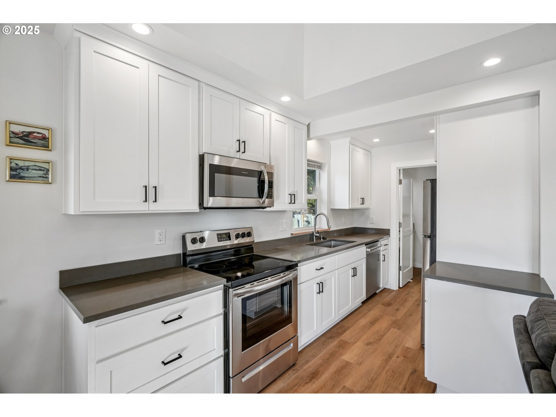 34326 Johnson's Landing Road, Unit E1 Scappoose, OR 97056 - Photo 9 of 21 a kitchen with stainless steel appliances granite countertop a stove a sink and a microwave