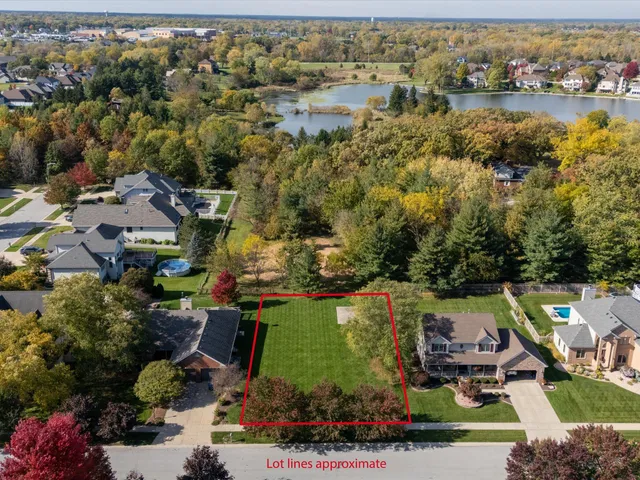 an aerial view of a house with a lake view