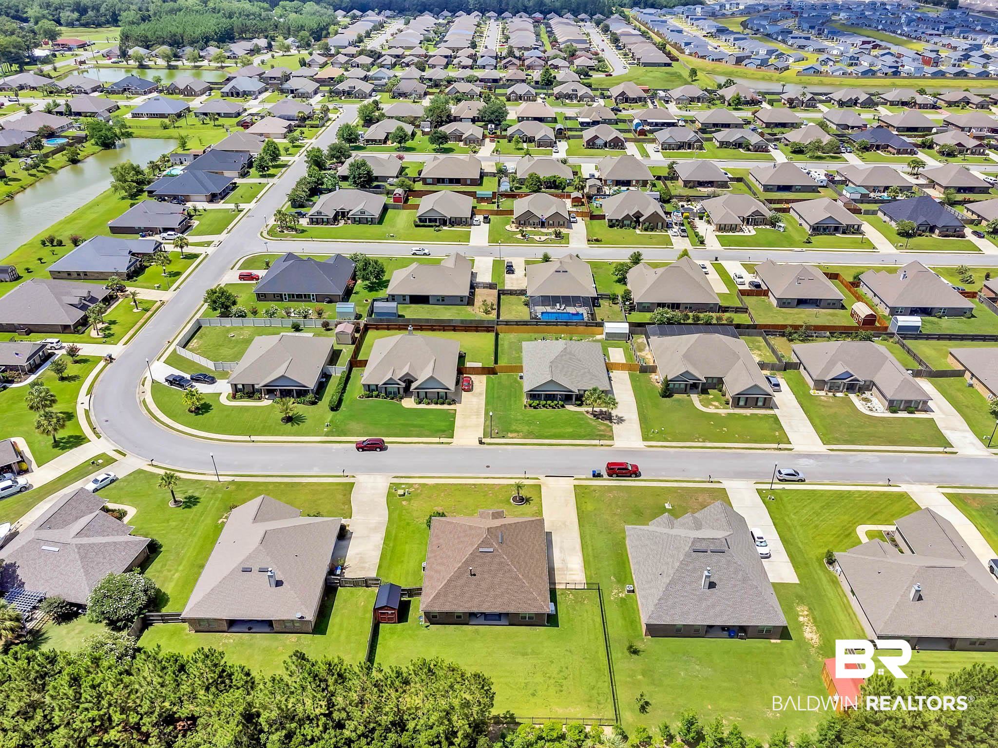 2049 Bourbon Street Foley, AL 36535 - Photo 50 of 56 Aerial perspective of suburban area featuring a large body of water