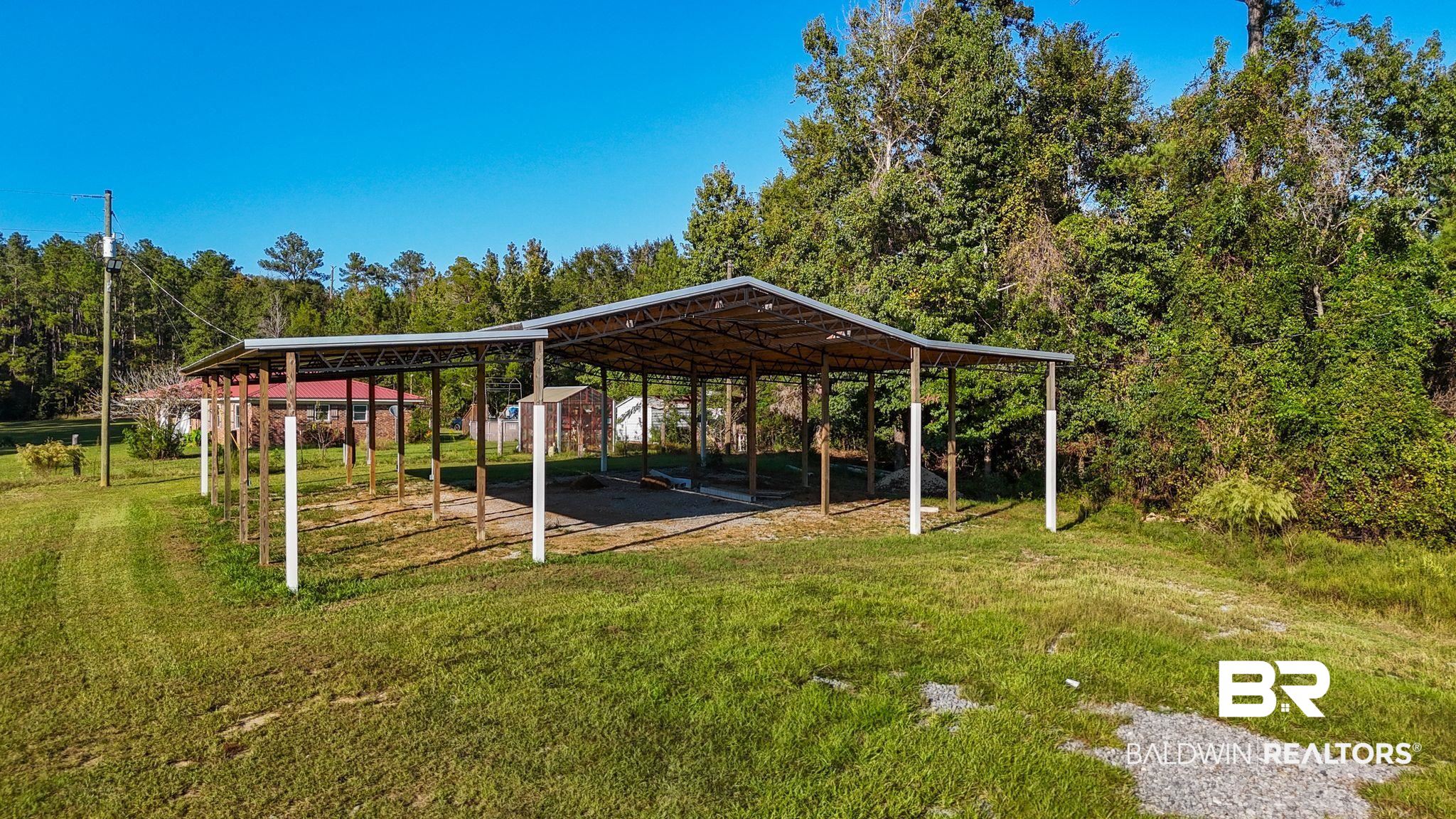 888 Mobile Cut-Off Road St. Stephens, AL 36569 - Photo 40 of 54 View of grassy yard featuring a carport