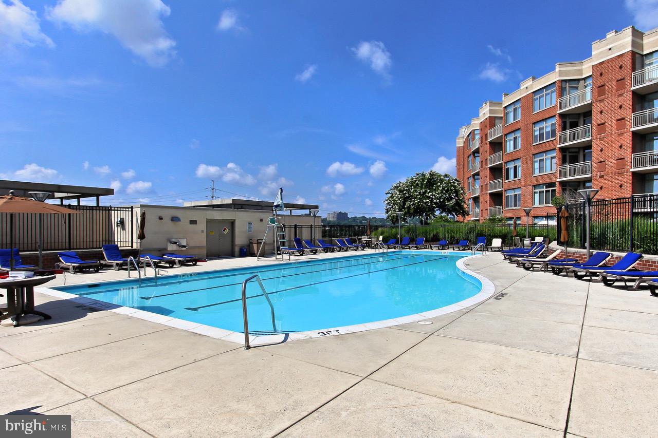 3650 South Glebe Road, Unit 147 Arlington, VA 22202 - Photo 19 of 31 a view of a patio with swimming pool table and chairs