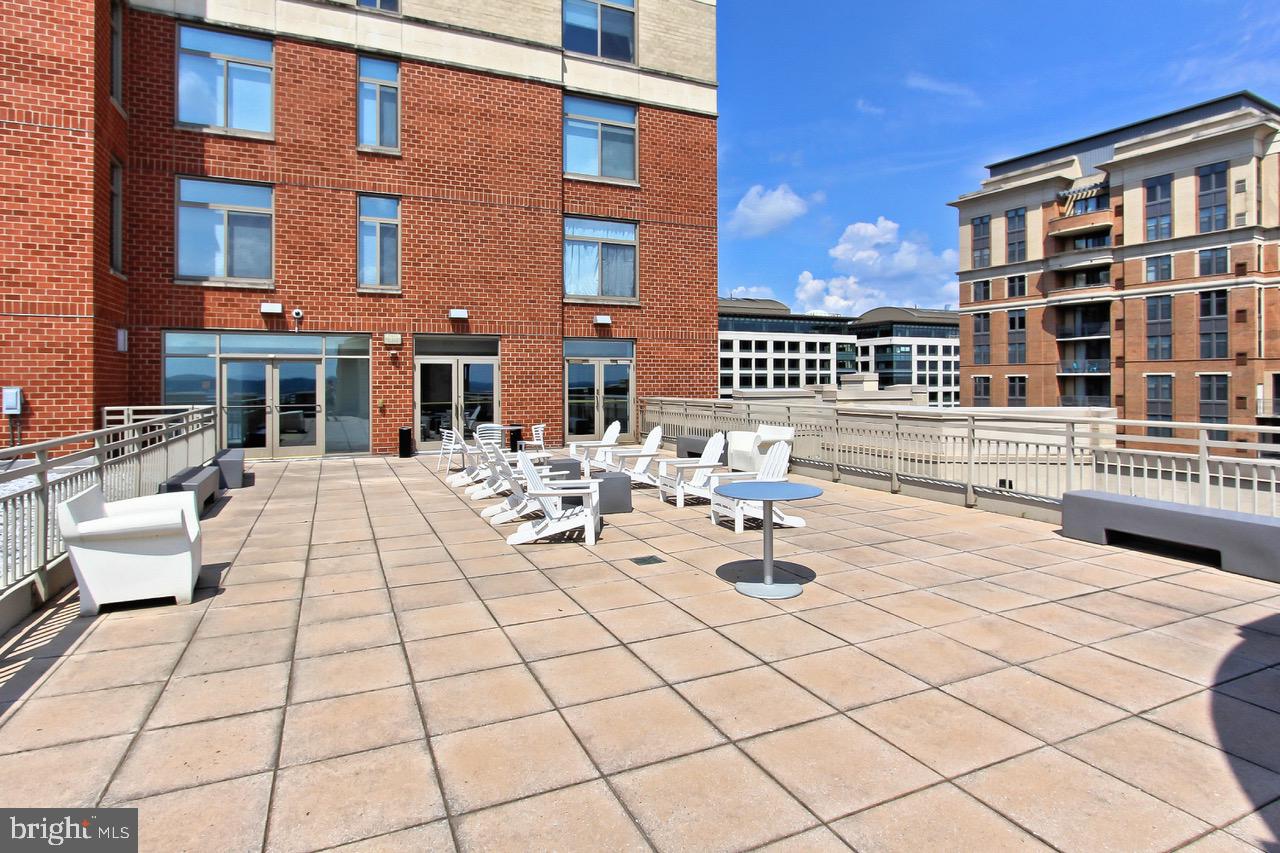 3650 South Glebe Road, Unit 147 Arlington, VA 22202 - Photo 26 of 31 a view of a building with dining table and chairs