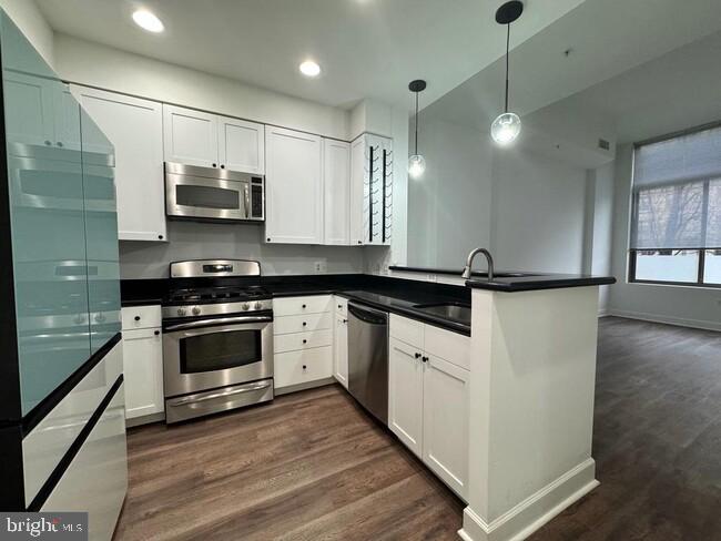 3650 South Glebe Road, Unit 147 Arlington, VA 22202 - Photo 3 of 31 a kitchen with stainless steel appliances a sink stove and refrigerator