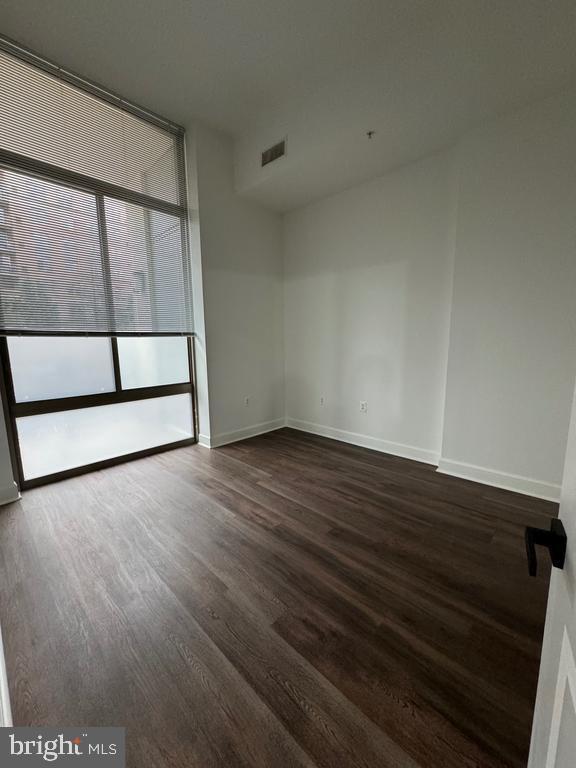 3650 South Glebe Road, Unit 147 Arlington, VA 22202 - Photo 8 of 31 an empty room with wooden floor and windows