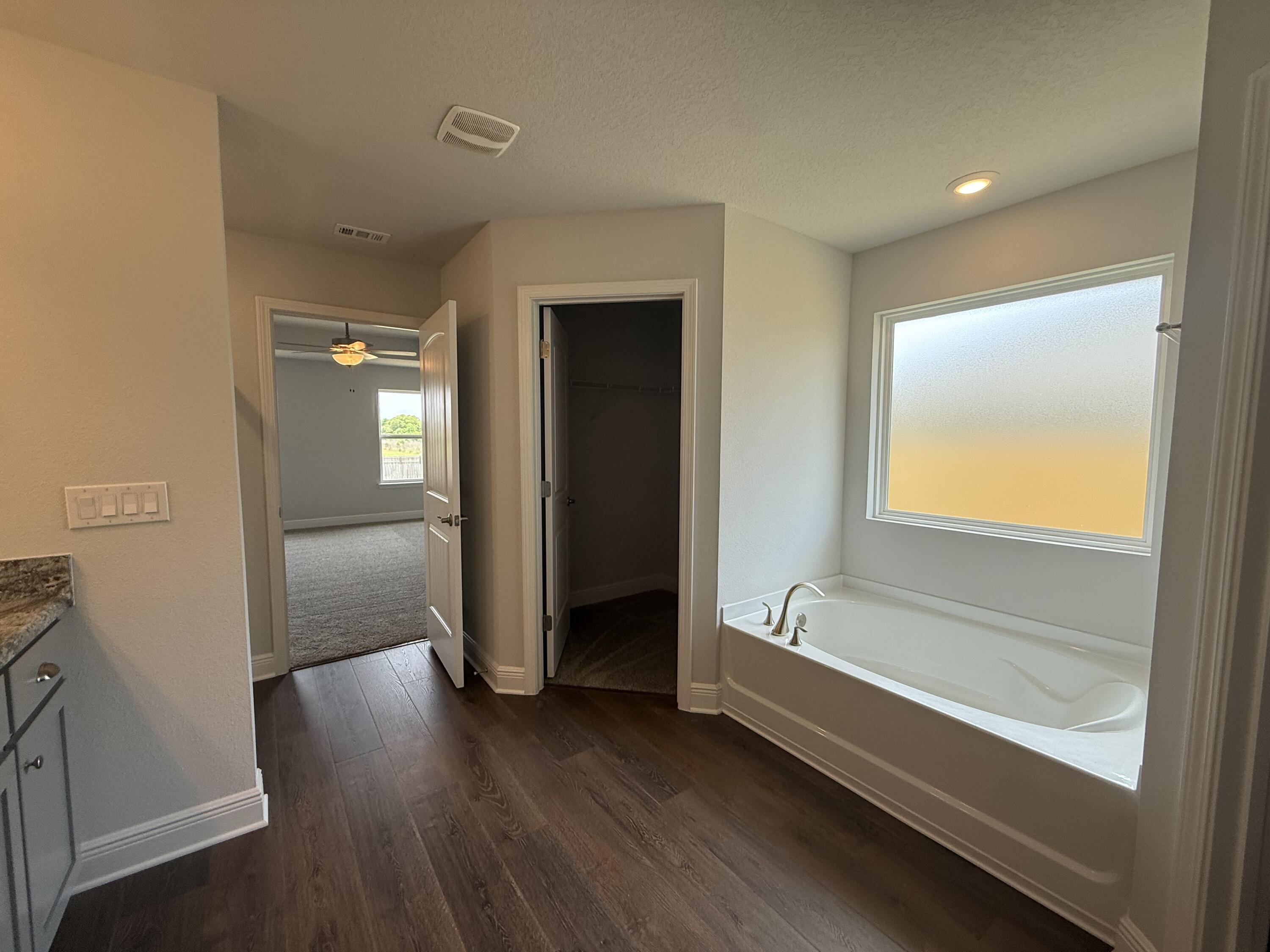 6004 Crocket Cove Crestview, FL 32539 - Photo 22 of 24 a spacious bathroom with a bathtub and a shower