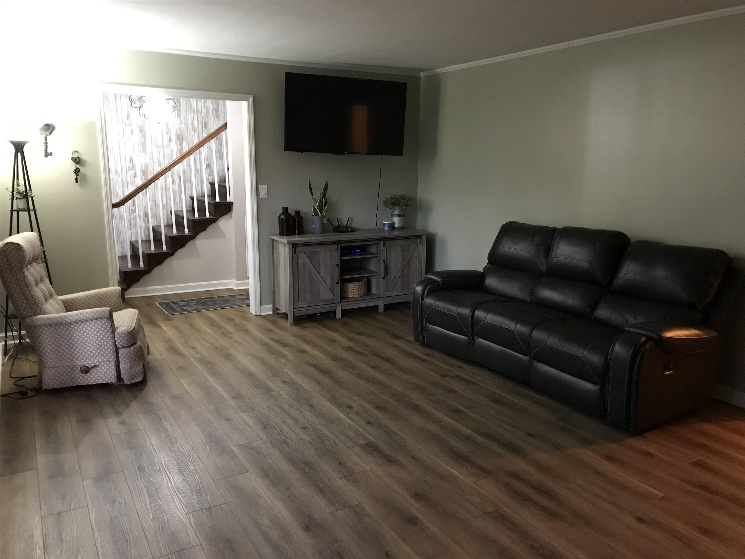 1201 Landgrave Street Georgetown, SC 29440 - Photo 13 of 38 Living room featuring ornamental molding, wood finished floors, and stairway