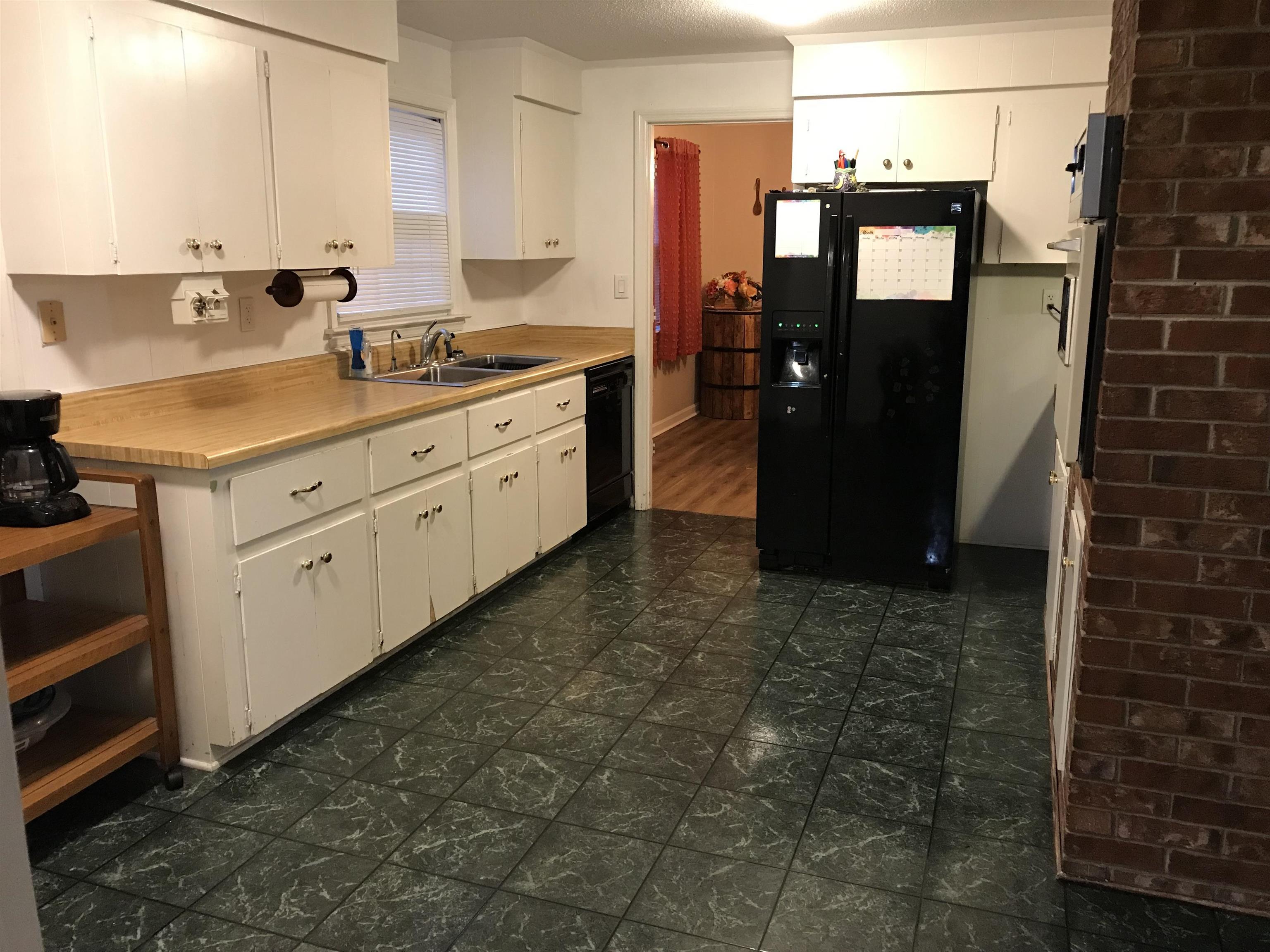 1201 Landgrave Street Georgetown, SC 29440 - Photo 15 of 38 Kitchen with light countertops, black appliances, and white cabinets