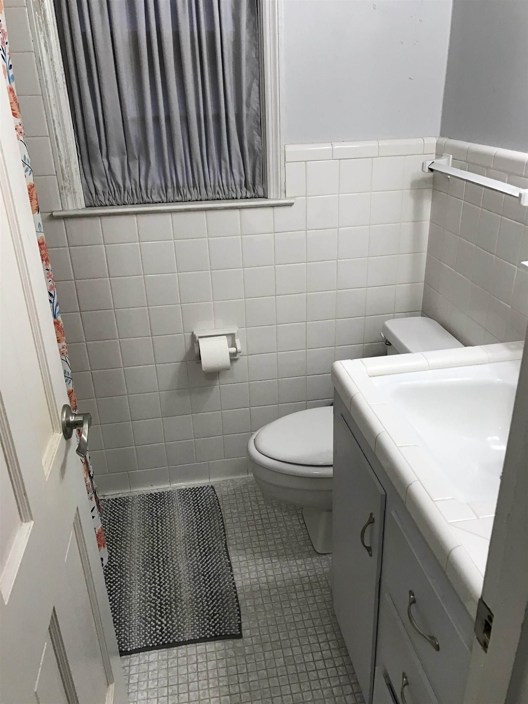1201 Landgrave Street Georgetown, SC 29440 - Photo 27 of 38 Bathroom with light tile patterned flooring, vanity, tile walls, curtained shower, and a wainscoted wall
