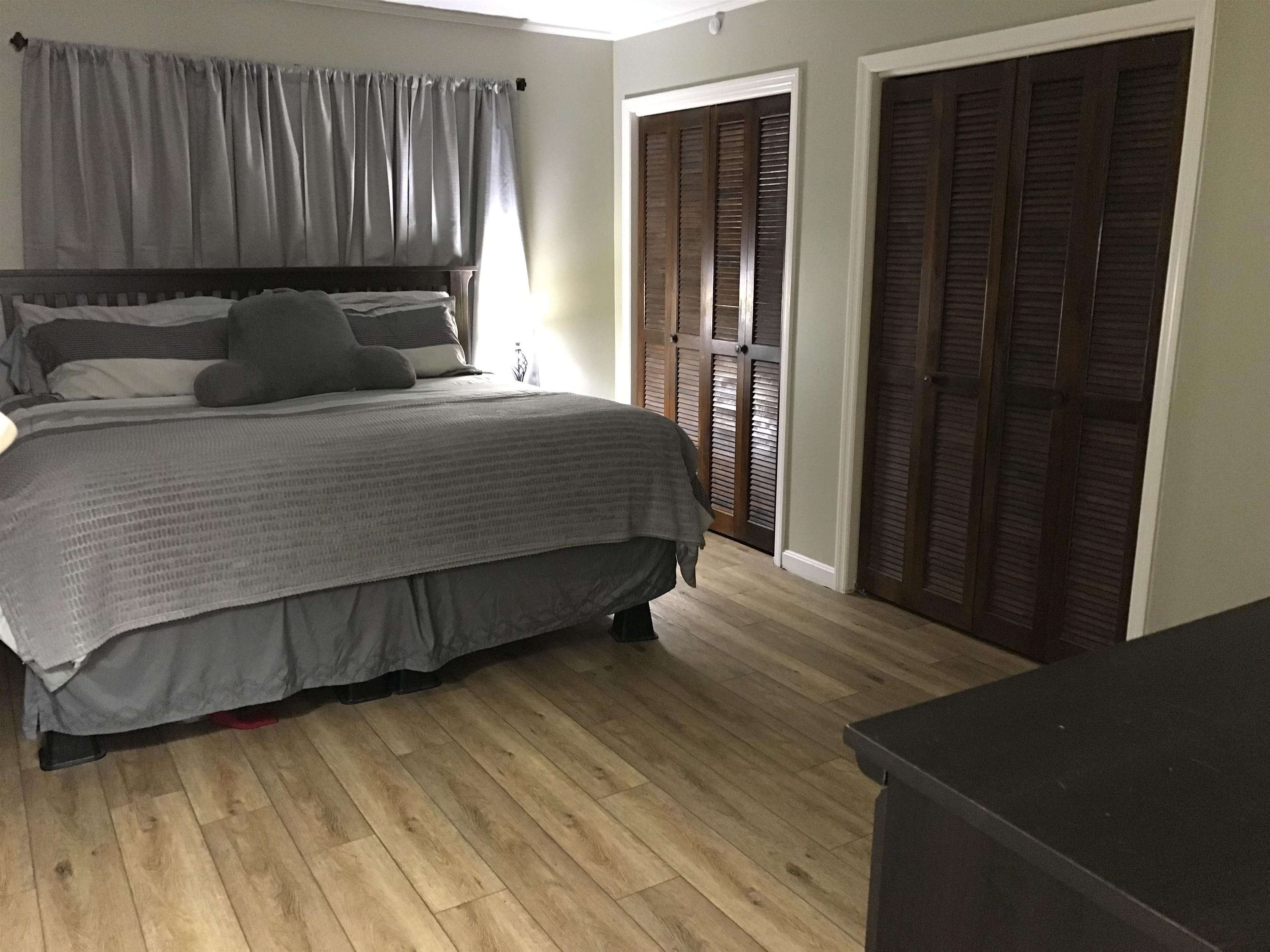 1201 Landgrave Street Georgetown, SC 29440 - Photo 35 of 38 Bedroom featuring multiple closets, light wood-style floors, and ornamental molding