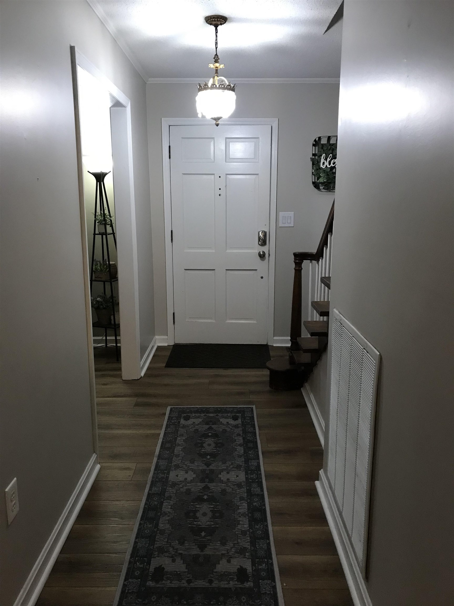 1201 Landgrave Street Georgetown, SC 29440 - Photo 9 of 38 Doorway to outside with wood finished floors, stairs, and crown molding