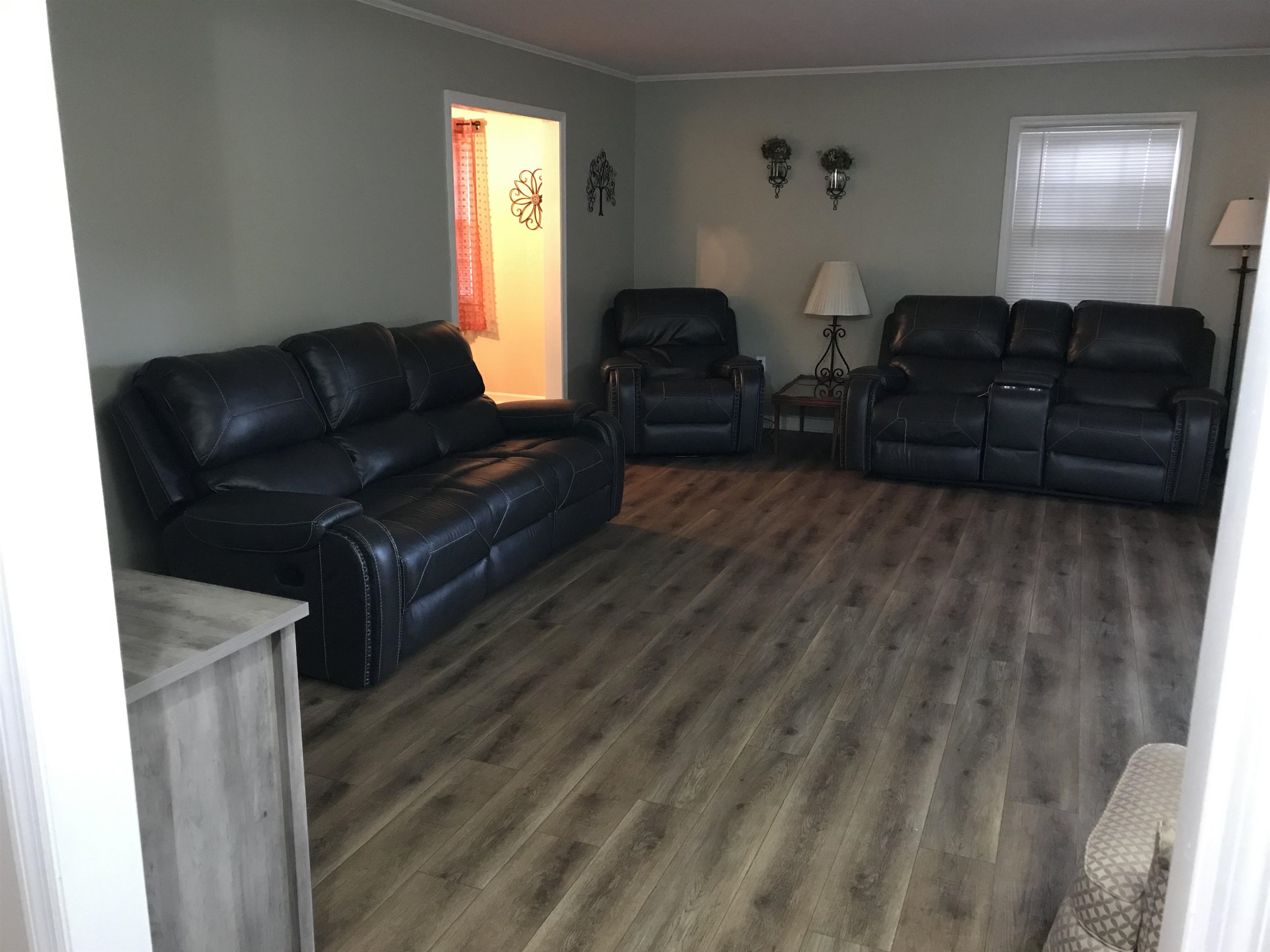 1201 Landgrave Street Georgetown, SC 29440 - Photo 10 of 38 Living area featuring crown molding and dark wood-style floors