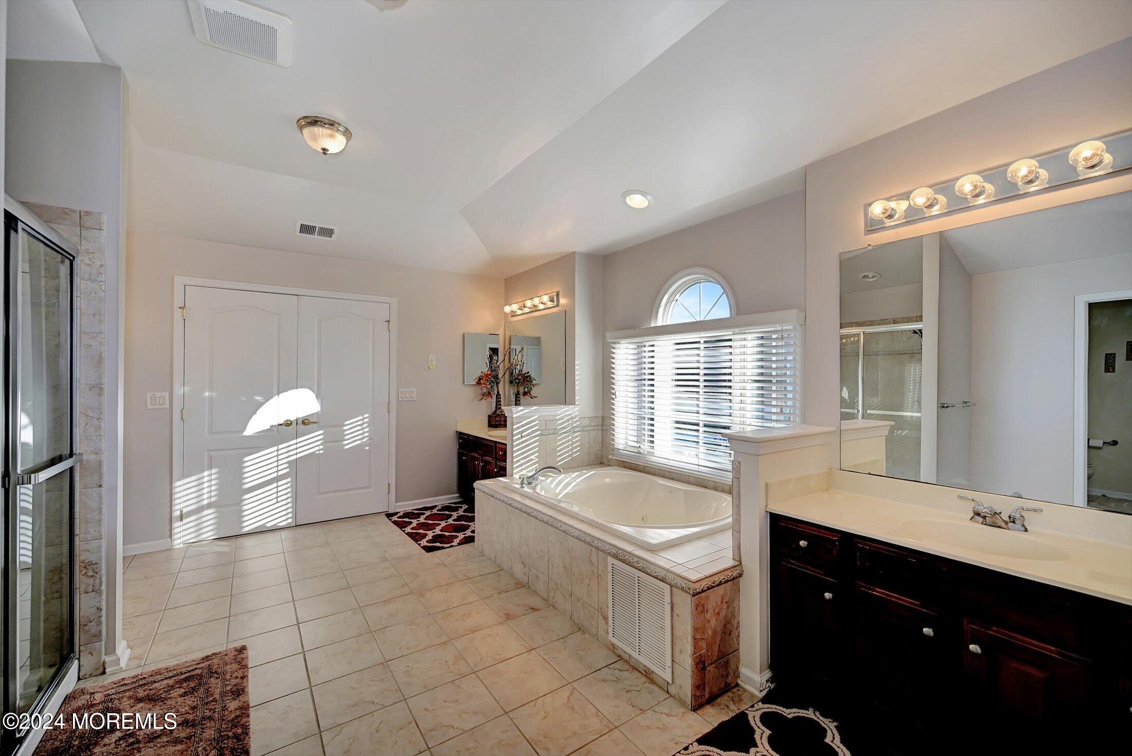 25 Wilson Boulevard Jackson, NJ 08527 - Photo 36 of 61 a large spacious bathroom with a tub sink and mirror