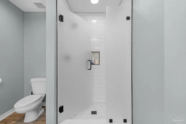 a view of an entryway with wooden floor and door