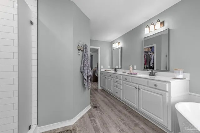 a bathroom with a sink mirror vanity and toilet