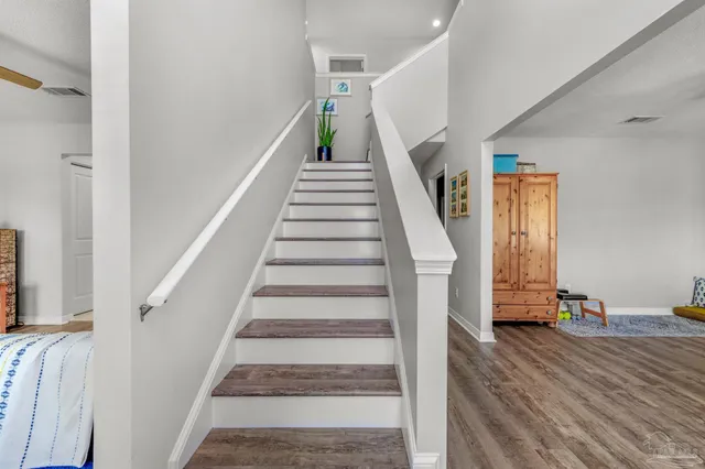 a view of room with furniture and wooden floor