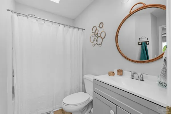 a kitchen with kitchen island granite countertop white cabinets white appliances a sink and a window