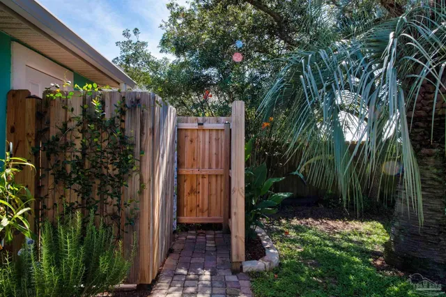 a backyard of a house with table and chairs