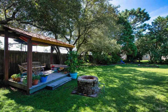 a view of a yard with plants and trees