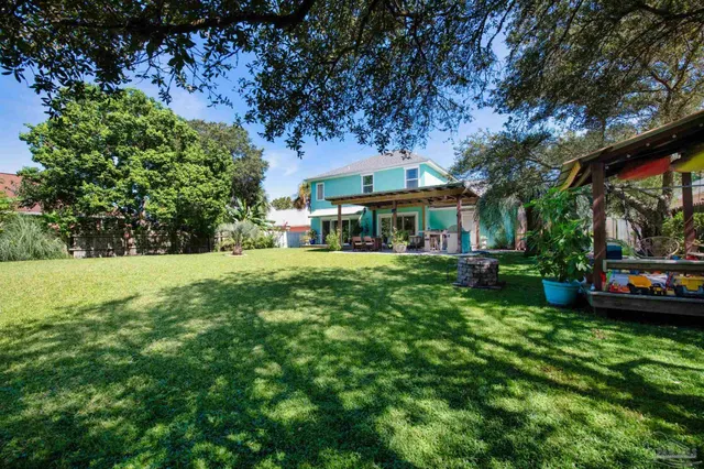 a view of a cafe with a table and chairs under an umbrella