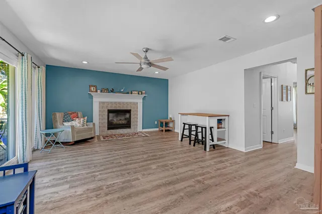 a living room with furniture fireplace and a window
