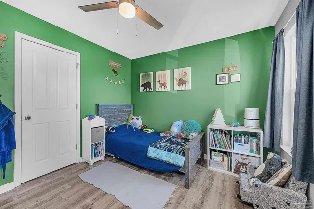 a bedroom with a bed and a dresser