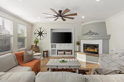 a living room with furniture a fireplace and a flat screen tv
